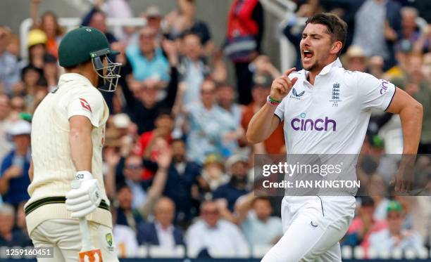 England's Josh Tongue celebrates taking the wicket of Australia's David Warner for 66 runs on day one of the second Ashes cricket Test match between...