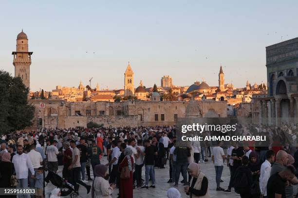 Muslim worshippers gather at the al-Aqsa mosque compound in Jerusalem to perform Eid Al-Adha morning prayers, on June 28 with the background showing...