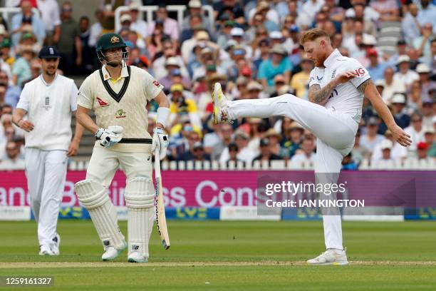 England's Josh Tongue and Australia's Steven Smith look on as England's captain Ben Stokes reacts after bowling on day one of the second Ashes...