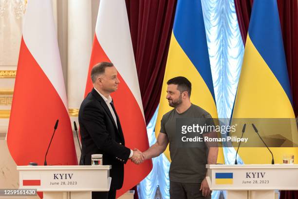 Ukrainian President Volodymyr Zelensky shakes hands with Poland's President Andrzej Duda after their joint press briefing together with Lithuania's...