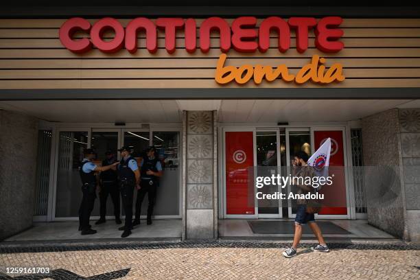 Police take security measures as the demonstrators get on the streets outside the grocery stores to protest against low wages during the 'National...