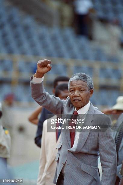 Anti-apartheid leader and African National Congress member Nelson Mandela raises a clenched fist as he arrives to address a mass rally on February...