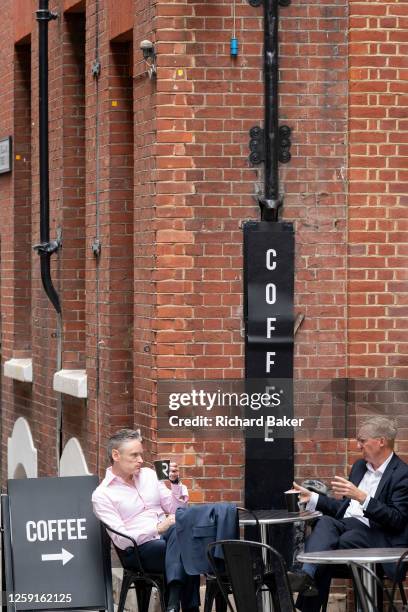 Two businessmen take an afternoon coffee break on Telegraph Street in the City of London, the capital's financial district, on 27th June 2023, in...