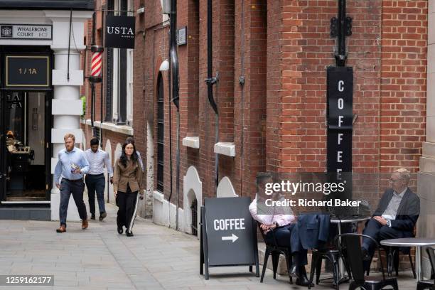 Two businessmen take an afternoon coffee break on Telegraph Street in the City of London, the capital's financial district, on 27th June 2023, in...