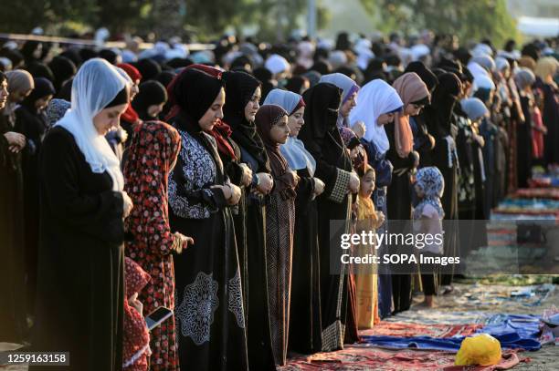 Palestinian women perform Eid al-Adha prayers in Khan Yunis, southern Gaza Strip.