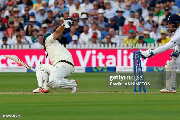 Bails fly as England's Jonny Bairstow takes the wicket of Australia's Travis Head for 77 runs on day one of the second Ashes cricket Test match...