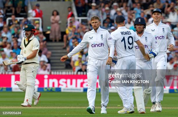 England's Jonny Bairstow and England's Joe Root celebrates dismissing Australia's Travis Head for 77 runs on day one of the second Ashes cricket Test...