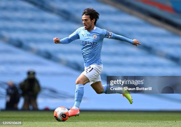 David Silva of Manchester City runs with the ball during the Premier League match between Manchester City and Norwich City at Etihad Stadium on July...