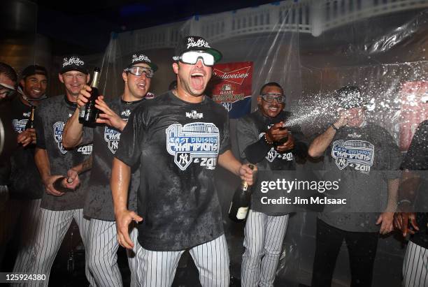 Nick Swisher of the New York Yankees celebrates after clinching the American League East division against the Tampa Bay Rays on September 21, 2011 at...