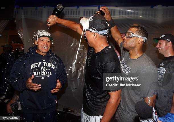 Reggie Jackson, Alex Rodriguez and Robinson Cano of the New York Yankees of the New York Yankees celebrate after clinching the American League East...