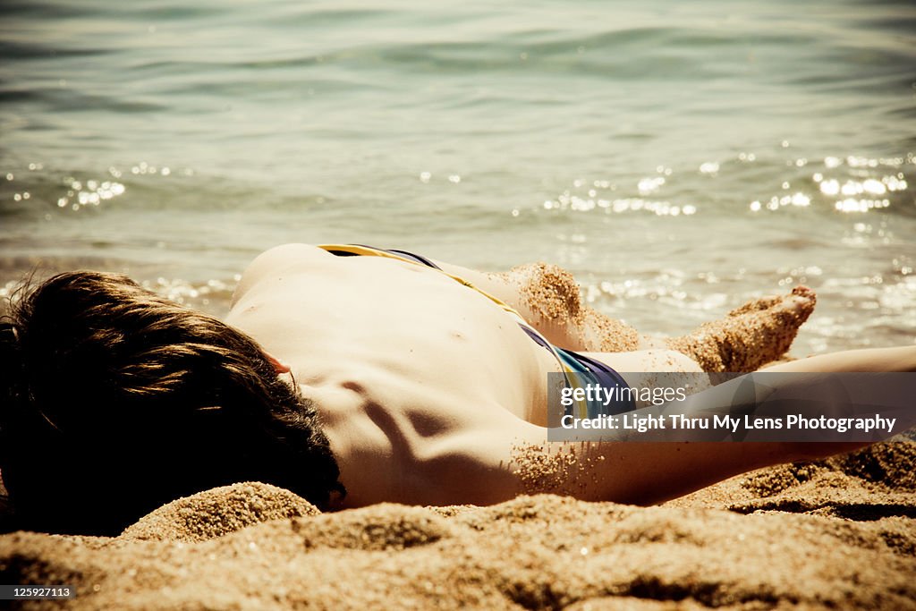 Kid sunbathing at beach