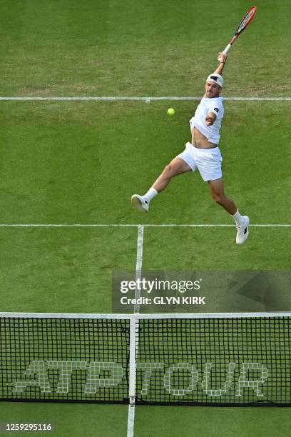 Player Tommy Paul jumps to play a return to Argentina's Sebastian Baez during their men's singles round of 16 tennis match at the Rothesay Eastbourne...