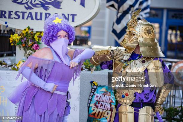Cosplayers Faeren Adams as Lumpy Space Princess from "Adventure Time" and Christopher Canole as Dude Vader pose at the Comic-Con Shrine on July 26,...