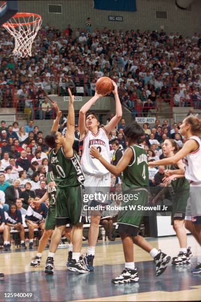 University of Connecticut player Kara Wolters shoots over the Michigan State defense during a game at Gampel Pavilion in Storrs, CT, 1996.