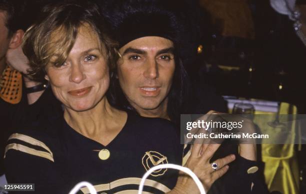 1980s: Steven Meisel and Lauren Hutton pose for a photo at an event in the late 1980s in New York City, New York.