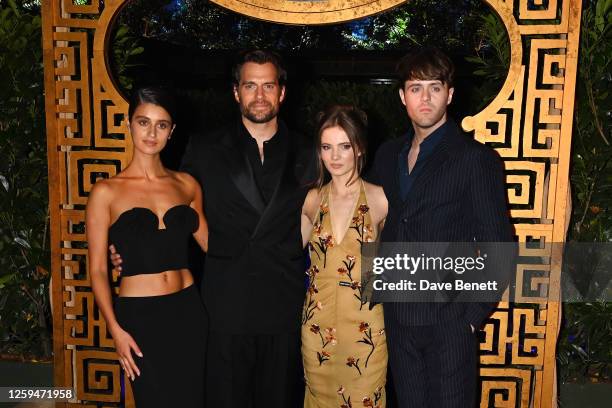 Anya Chalotra, Henry Cavill, Freya Allan and Joey Batey pose in front of The Witcher Maze during the UK Premiere of "The Witcher" Season 3 at...