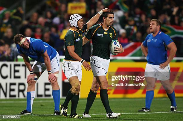 Ruan Pienaar of South Africa congratulates try scorer Jaque Fourie of South Africa during the IRB 2011 Rugby World Cup Pool B match between South...