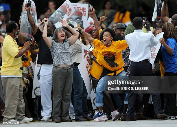 Demonstrators react after an apparent delay in the scheduled execution of convicted cop killer Troy Davis at the Georgia Diagnostic and...