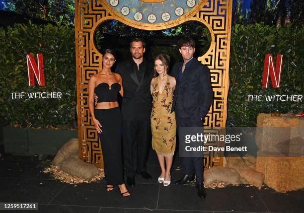 Anya Chalotra, Henry Cavill, Freya Allan and Joey Batey pose in front of The Witcher Maze during the UK Premiere of "The Witcher" Season 3 at...