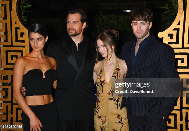 Anya Chalotra, Henry Cavill, Freya Allan and Joey Batey pose in front of The Witcher Maze during the UK Premiere of "The Witcher" Season 3 at...