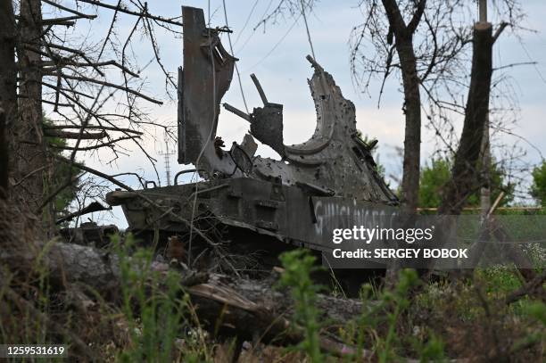 This photograph taken on June 28 shows a destroyed military armored vehicle in the village of Kurilovka, Kharkiv region, amid the Russian invasion of...