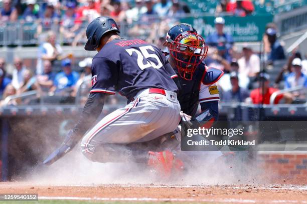 Byron Buxton of the Minnesota Twins is out at the home plate by Travis d'Arnaud of the Atlanta Braves during the fourth inning at Truist Park on June...