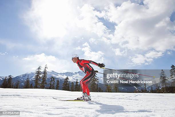 biathlon athlete quickly skis - biathlon ski stock pictures, royalty-free photos & images