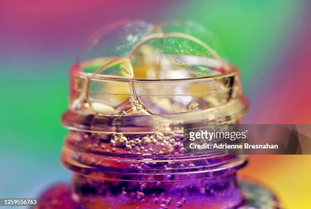 rainbow purple bubbly - overflowing glass stock-fotos und bilder
