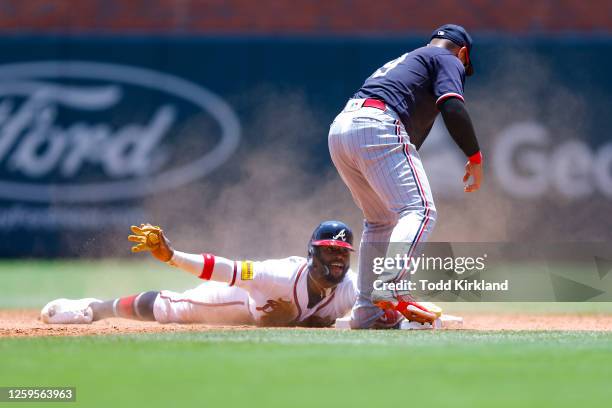 Michael Harris II of the Atlanta Braves steals second base as Donovan Solano of the Minnesota Twins defends during the fifth inning at Truist Park on...