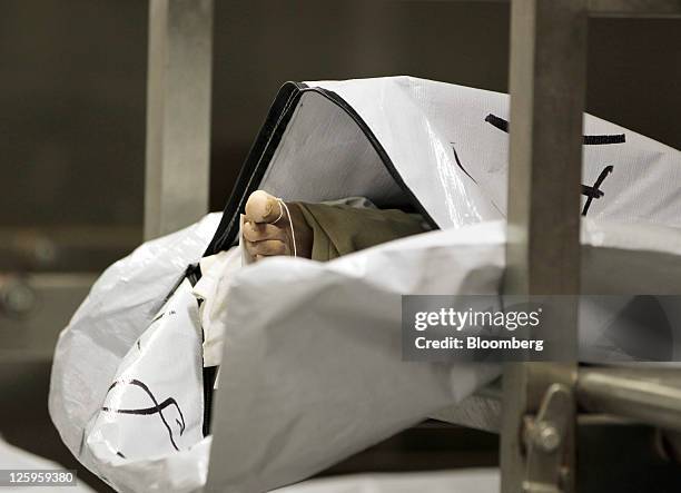 Foot is seen in an open body bag in a refrigerated room at the Wayne County Medical Examiner's office in Detroit, Michigan, U.S., on Wednesday, Sept....