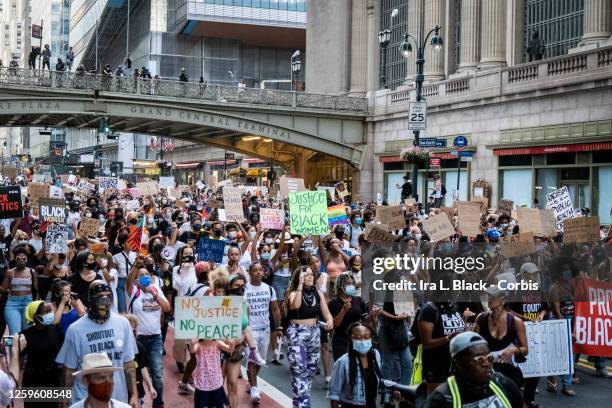 July 26: Hundreds of protesters carrying signs walk past Grand Central Station in Manhattan New York in support of Black Women. This non-violent...