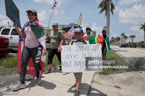 Protesters against a new immigration law march along Palm Beach Boulevard in Fort Myers, Florida, on June 28, 2023. Florida Governor Ron DeSantis...