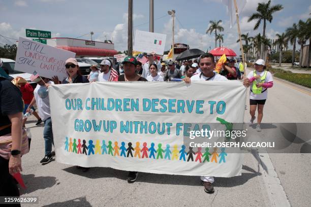 Protesters against a new immigration law march along Palm Beach Boulevard in Fort Myers, Florida, on June 28, 2023. Florida Governor Ron DeSantis...