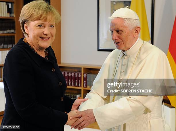 German-born Pope Benedict XVI shakes hands with German Chancellor Angela Merkel at the Chancellery in Berlin on September 22 the first day of the...
