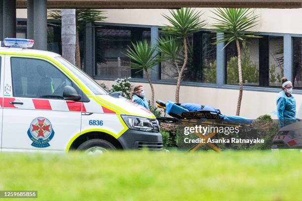 Ambulance service workers push a stretcher into the St Basil's homes for the Aged facility in Fawkner on July 27, 2020 in Melbourne, Australia....