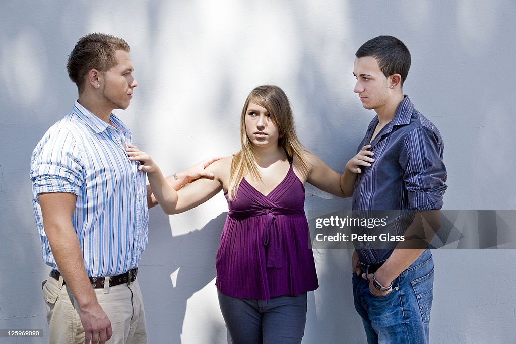 Caucasian female teen, 14 years old, separating a gay Caucasian male couple, both 19 years old