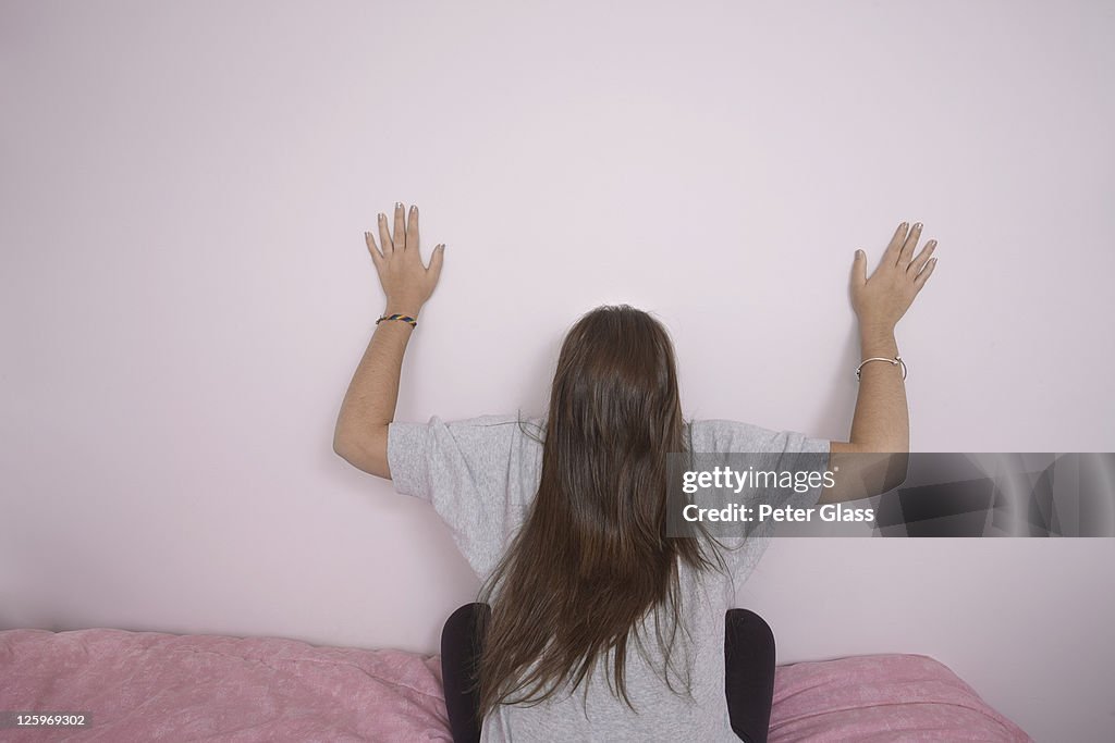 Caucasian female (16 years old) on her bed