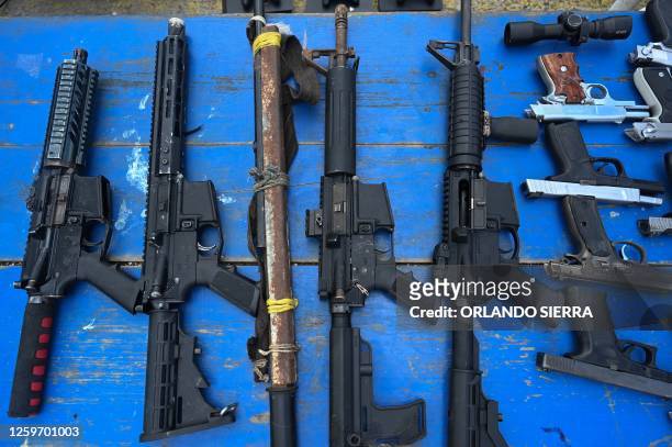 Picture of weapons seen as the Military Police of Public Order displays weapons, ammunition, drugs, mobile phones and other items seized to...