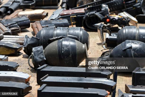 Members of the Military Police of Public Order display weapons, ammunition, drugs, mobile phones and other items seized to imprisoned members of the...