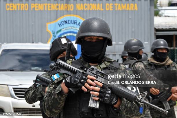 Members of the Military Police of Public Order stand guard outside the National Penitentiary "Francisco Morazan" as weapons, ammunition, drugs,...