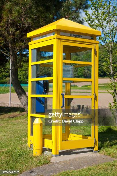 yellow phone box on st aubin's promenade in st aubin, jersey, channel islands - saint aubin stock pictures, royalty-free photos & images