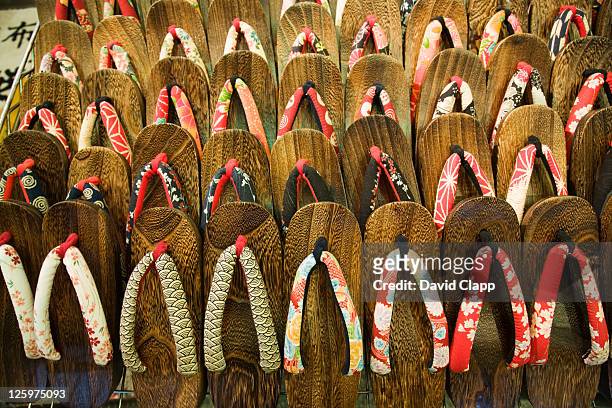 geta sandals, traditional wooden shoes worn with a kimono in a market, kyoto, japan - 下駄 ストックフォトと画像