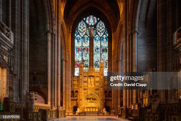 ornate altar and stained glass window at east end of liverpool anglican cathedral, merseyside, uk - liverpool cathedral stock pictures, royalty-free photos & images