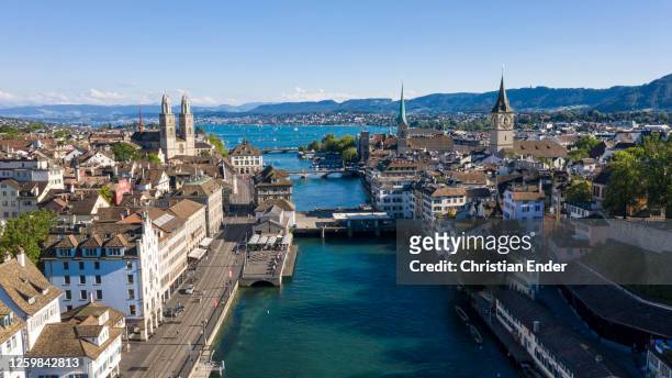 An aerial drone view of the city centre of Zurich, Limmat River, Lake Zurich, and the Grossmuenster Church stand during the coronavirus pandemic on...