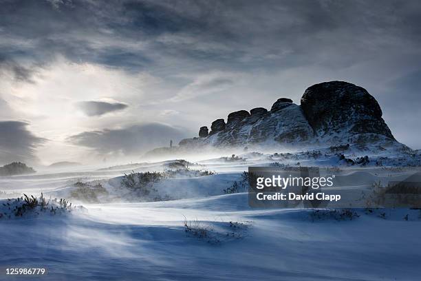 haytor rocks after a heavy snow fall, spin drift carried across the ground by strong winds, dartmoor, devon, england, uk, february 2009 - rock formation stock pictures, royalty-free photos & images