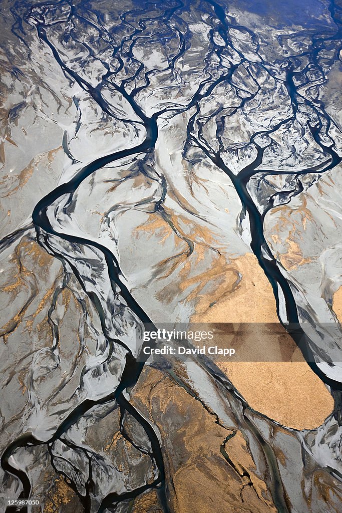 Aerial of braided, glacial river channels flowing into other where Godley River joins Lake Tekapo, Southern Alps, New Zealand