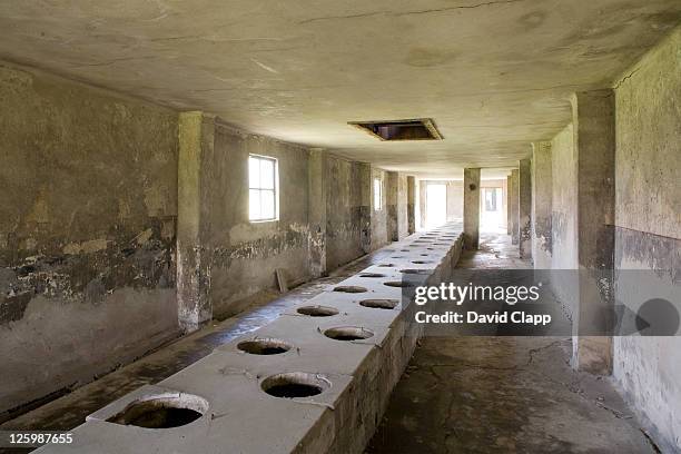 latrines in toilet block at birkenau, auschwitz concentration camp in poland - nazi concentration camp stock pictures, royalty-free photos & images