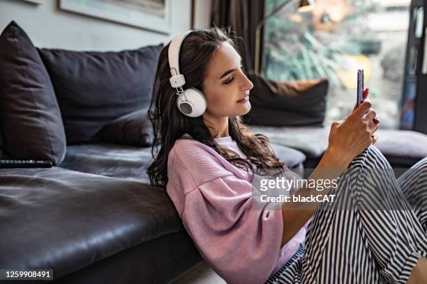young woman enjoying at home - listening imagens e fotografias de stock