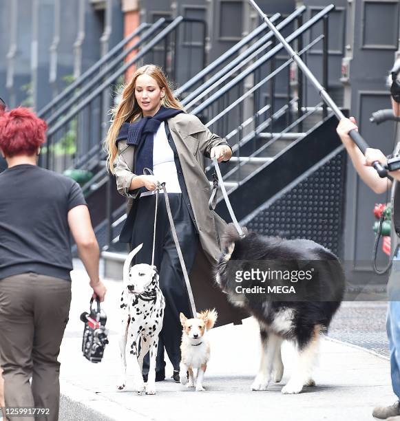Jennifer Lawrence is seen on set walking with three dogs on June 28, 2023 in NEW YORK, New York.