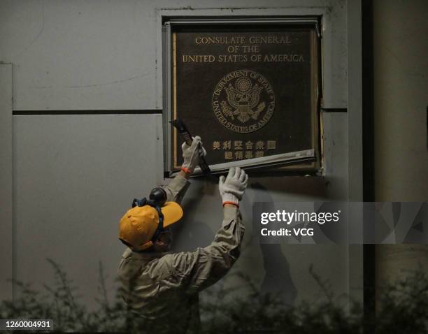 Worker removes a plaque of the US Consulate General in Chengdu on July 26, 2020 in Chengdu, Sichuan Province of China.